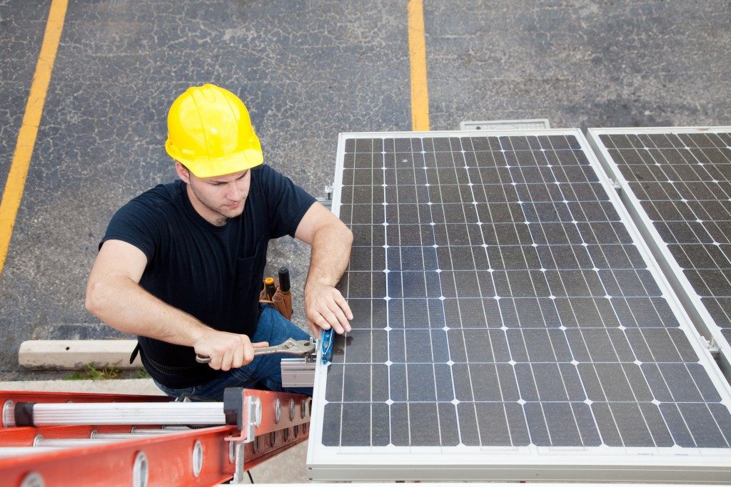 worker installing solar panel