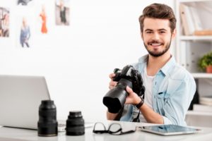 Photographer holding his camera