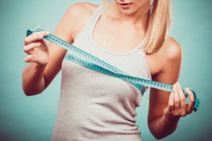 woman measuring her chest