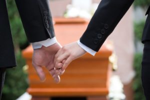 Two hands holding during a wake