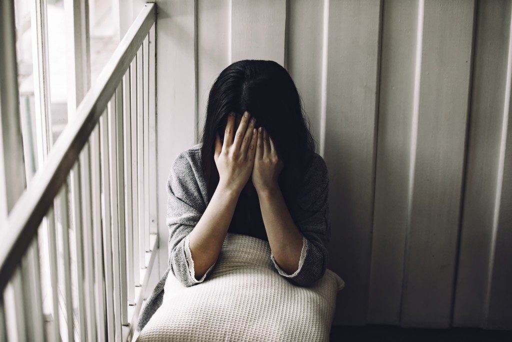 Depressed woman covering her face