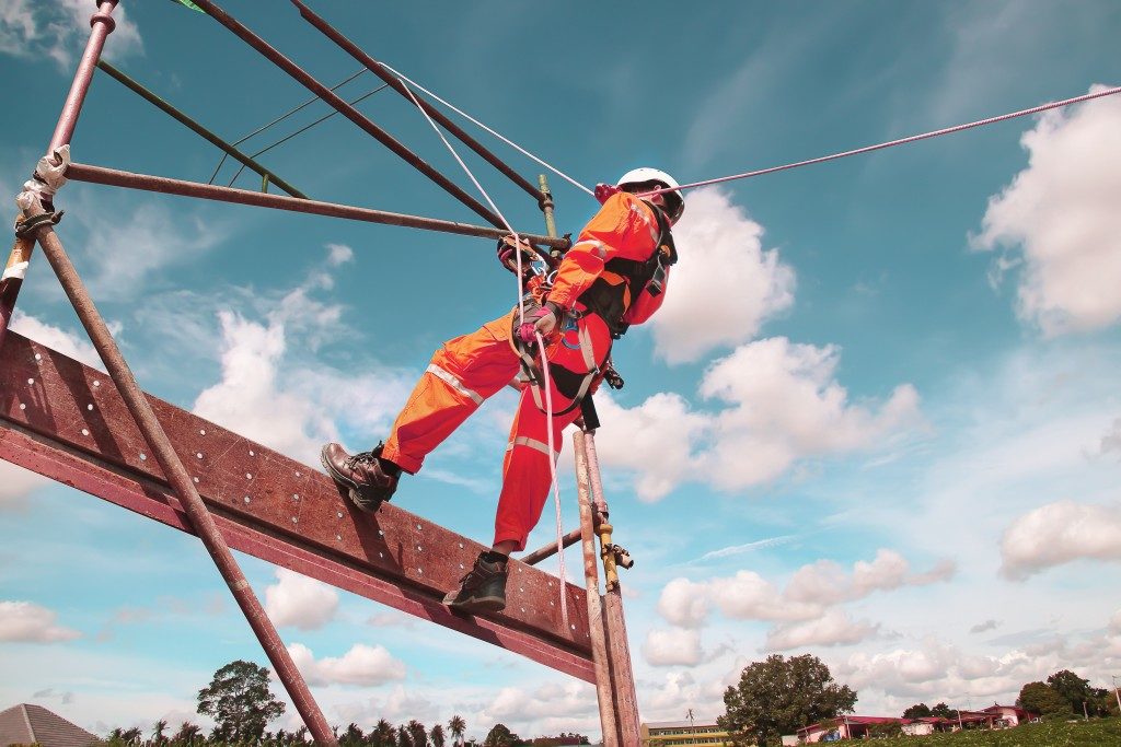 worker climbing on a steel beam