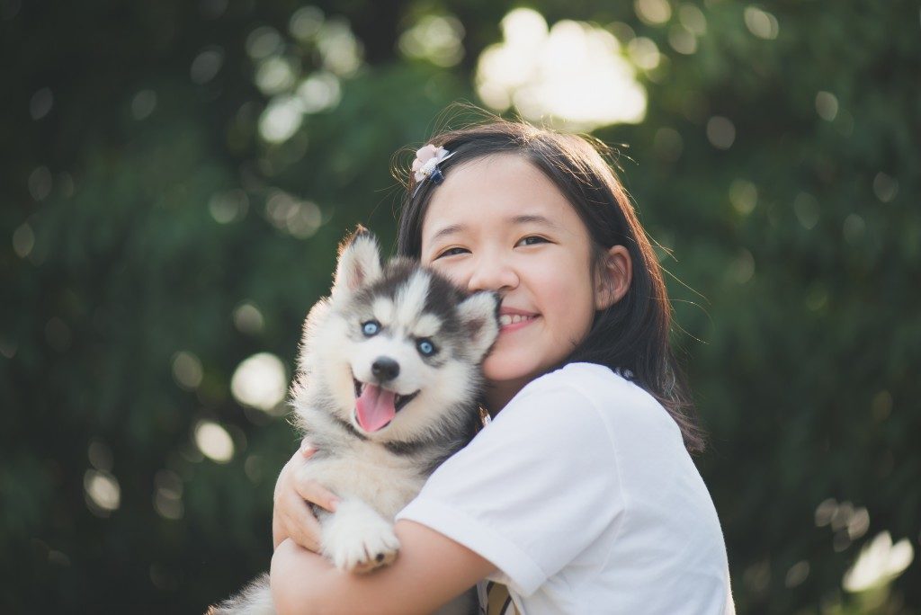 Little girl hugging her dog
