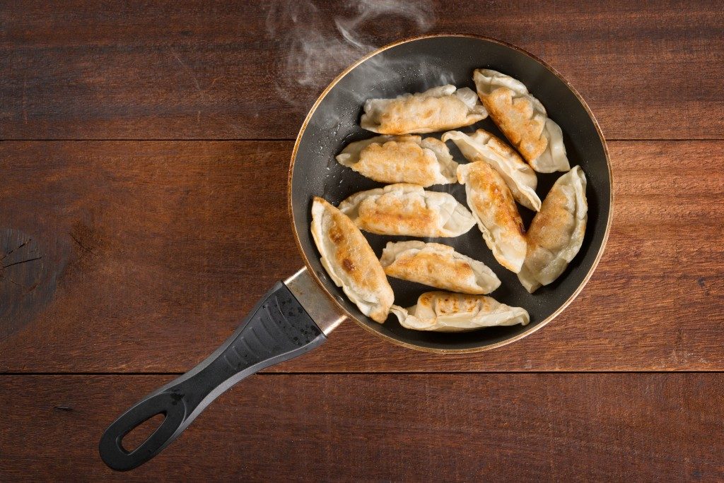 Top view fried dumplings in a frying pan