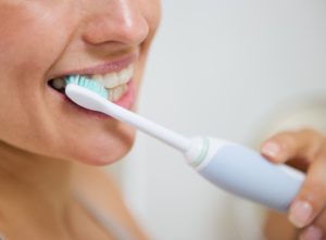 woman brushing her teeth