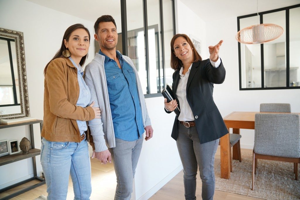 Real estate agent touring a couple
