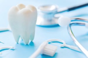 dental and oral health concept with teeth and dentist's tools
