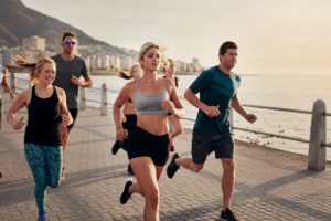 Group of young people doing running workout