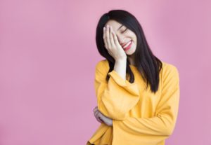 woman covering her face