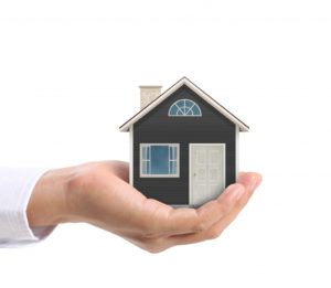 hand holding small home