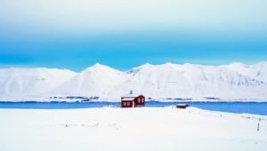 cabin near a frozen lake