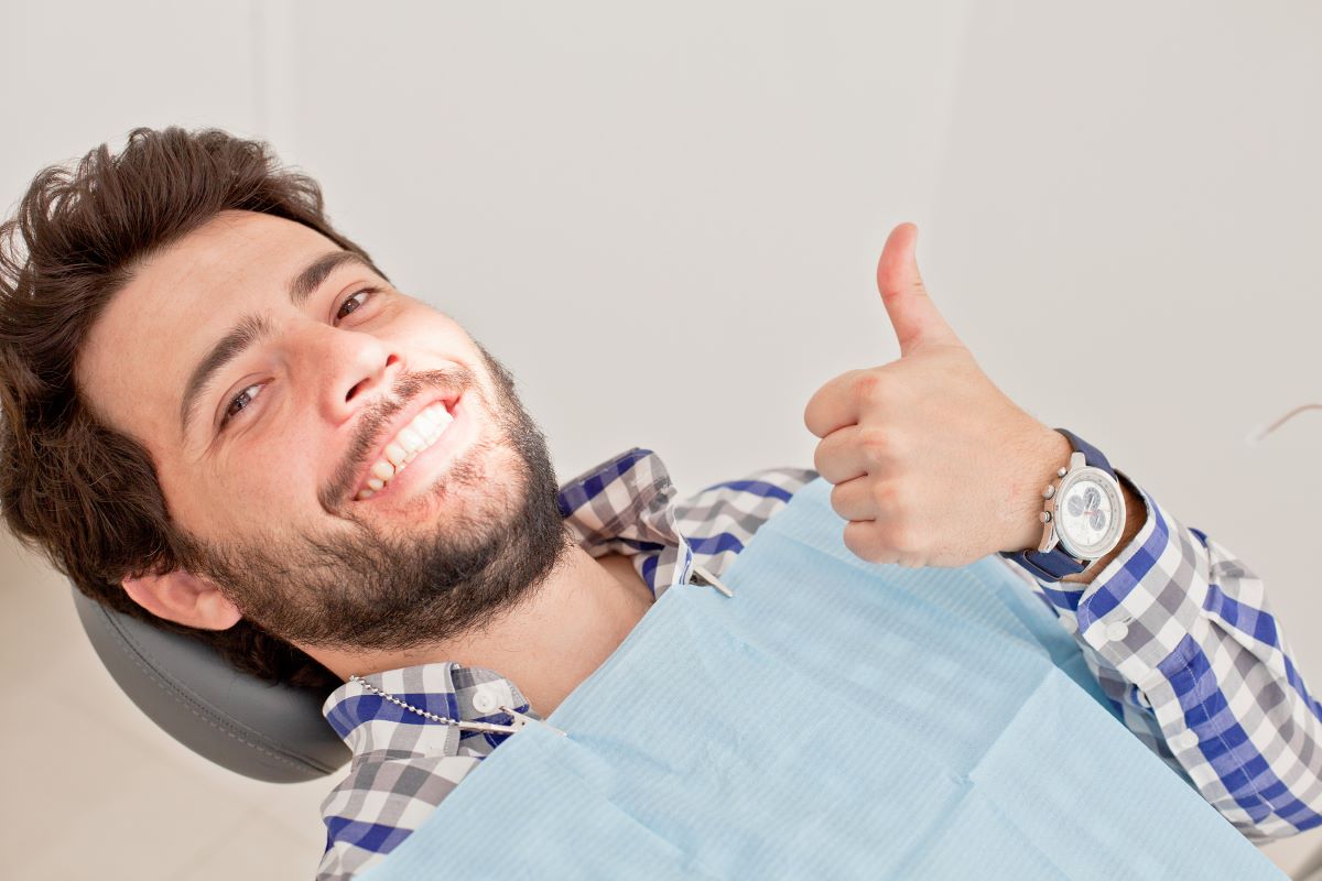 man smiling thumbs up dentist