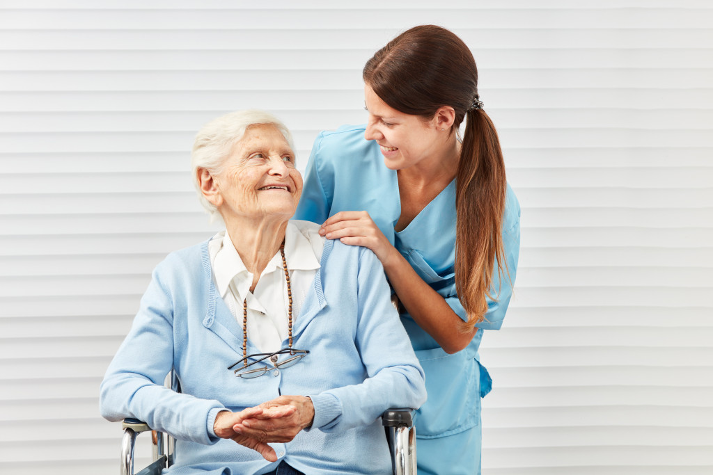 senior being assisted by a caregiver