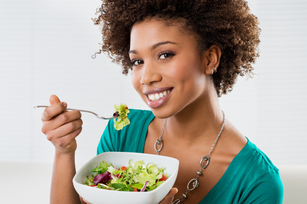 A woman eating healthy dishes