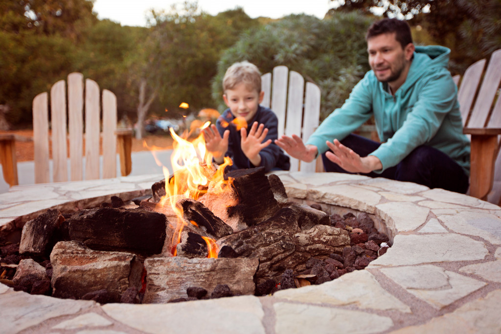 dad and son by the fire pit