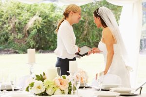 bride with wedding planner in beautiful garden wedding