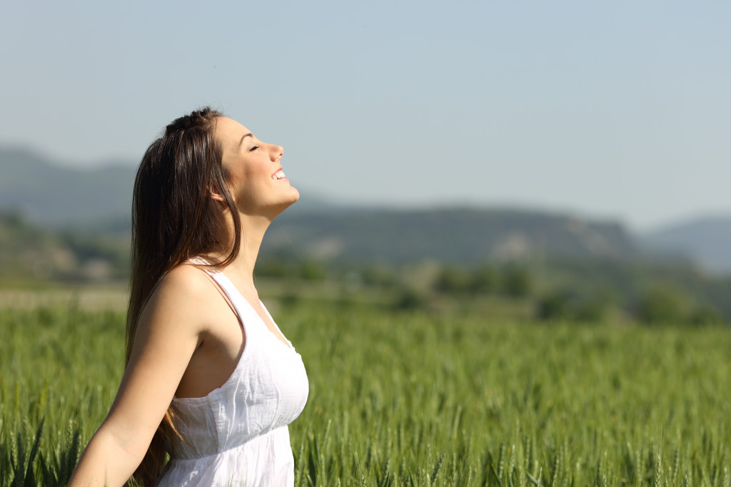 a woman breathing air outdoors