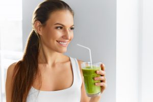 woman drinking green smoothie