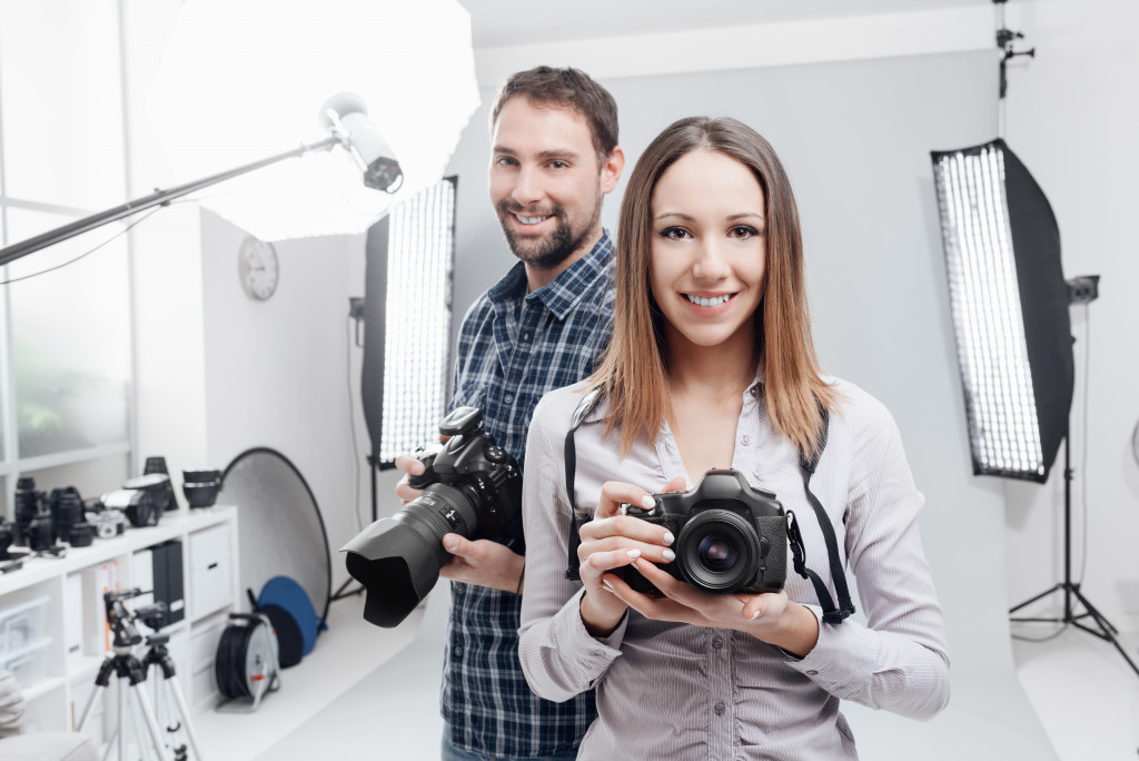 Two photographers in their studio with equipment