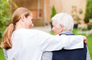 a senior woman talking to a caregiver