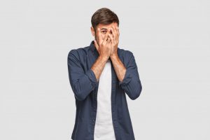 man covering his face